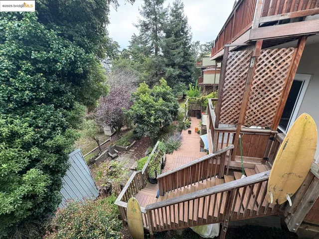 a view of balcony with wooden floor and fence