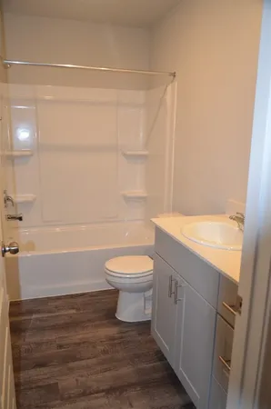 a bathroom with a toilet a sink and bathtub