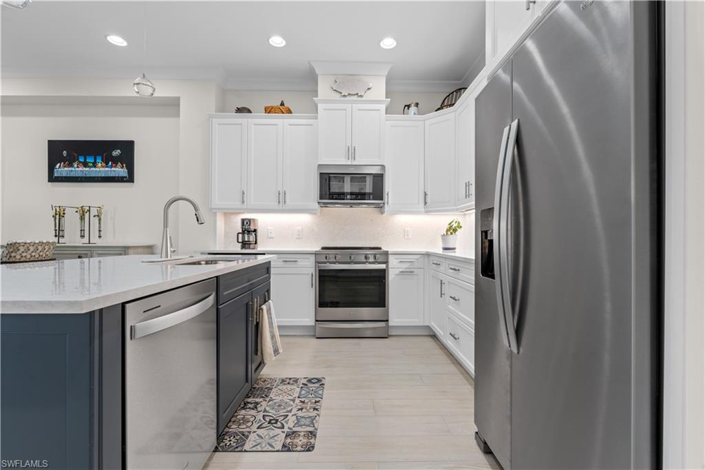 8781 Yucatan Court Naples, FL 34113 - Photo 13 of 36 a kitchen with stainless steel appliances granite countertop a refrigerator and a stove top oven