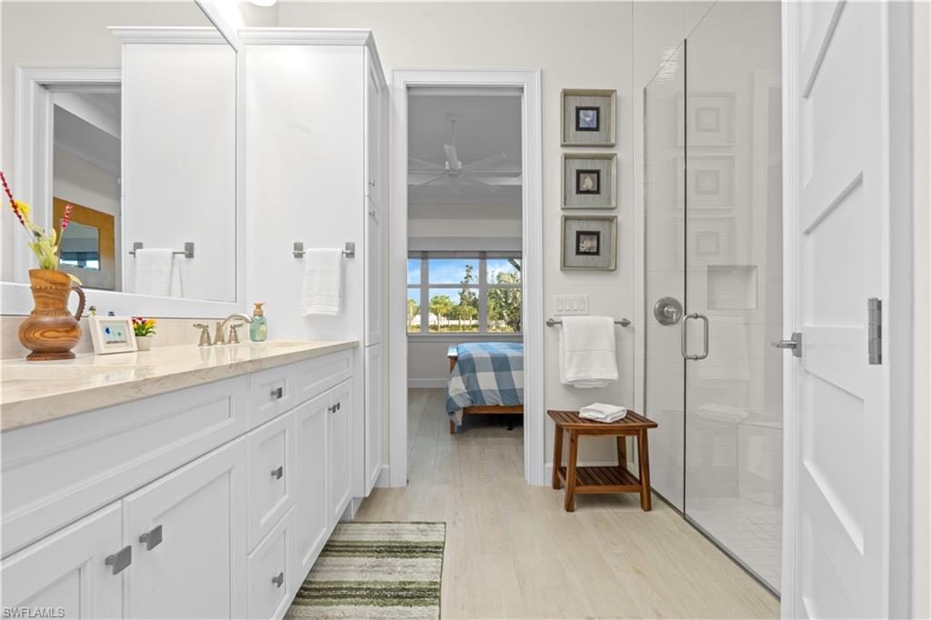 8781 Yucatan Court Naples, FL 34113 - Photo 20 of 36 a spacious bathroom with a double vanity sink and a mirror