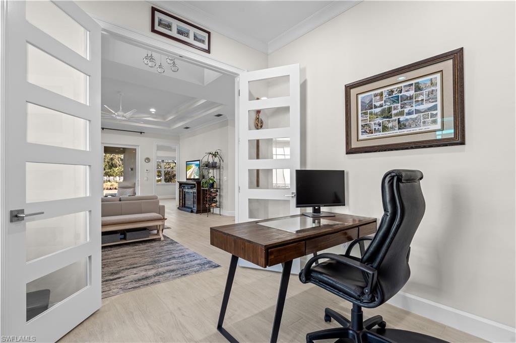 8781 Yucatan Court Naples, FL 34113 - Photo 22 of 36 a workspace with furniture and wooden floor