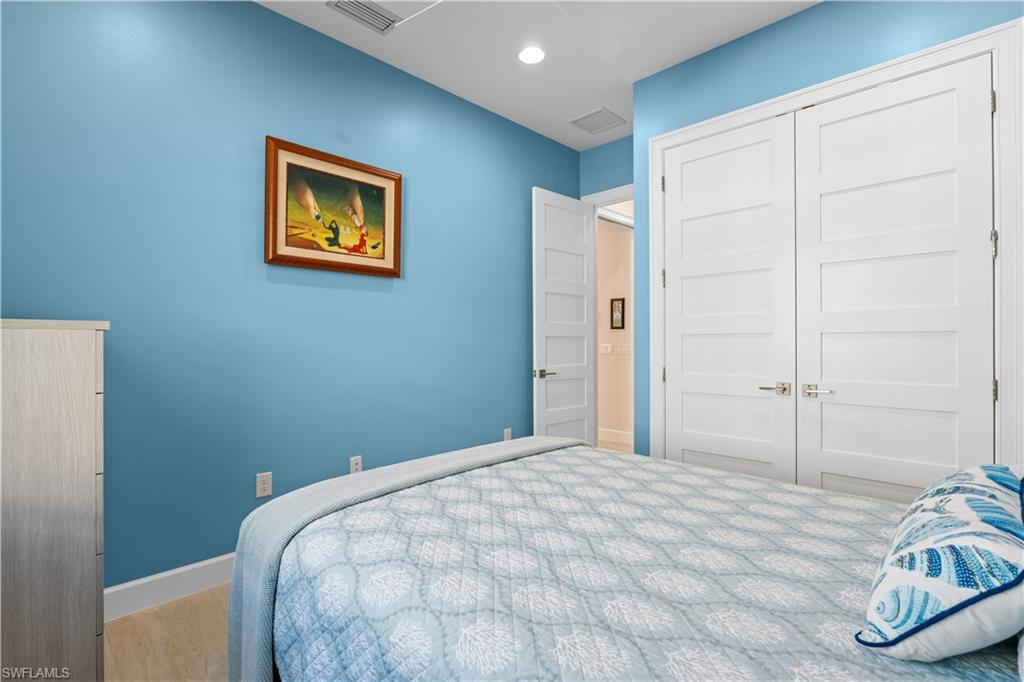 8781 Yucatan Court Naples, FL 34113 - Photo 24 of 36 a bedroom with a bed and a window