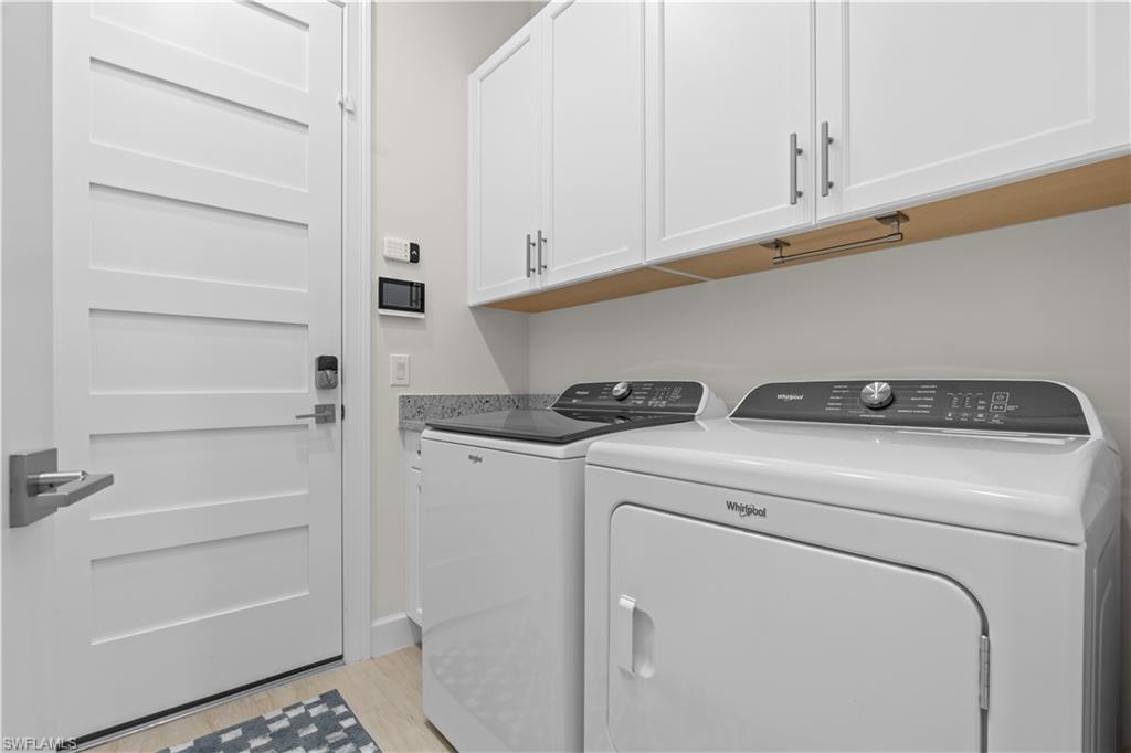 8781 Yucatan Court Naples, FL 34113 - Photo 26 of 36 a utility room with dryer and washer
