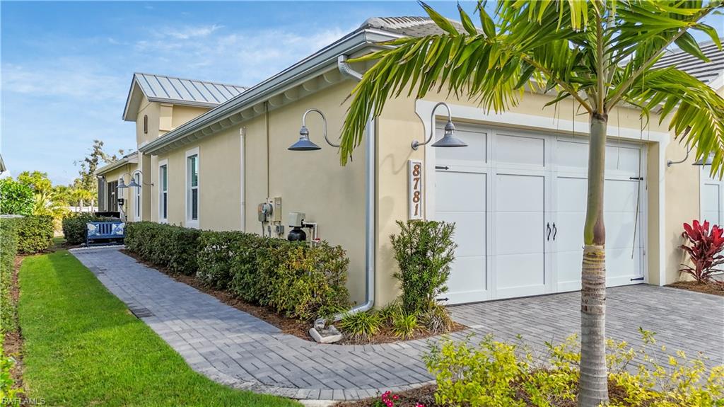 8781 Yucatan Court Naples, FL 34113 - Photo 5 of 36 a front view of a house with garden