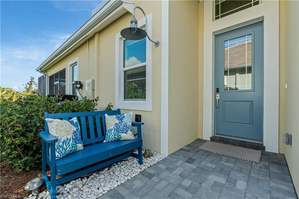 8781 Yucatan Court Naples, FL 34113 - Photo 6 of 36 a view of a house with couches chairs and wooden floor