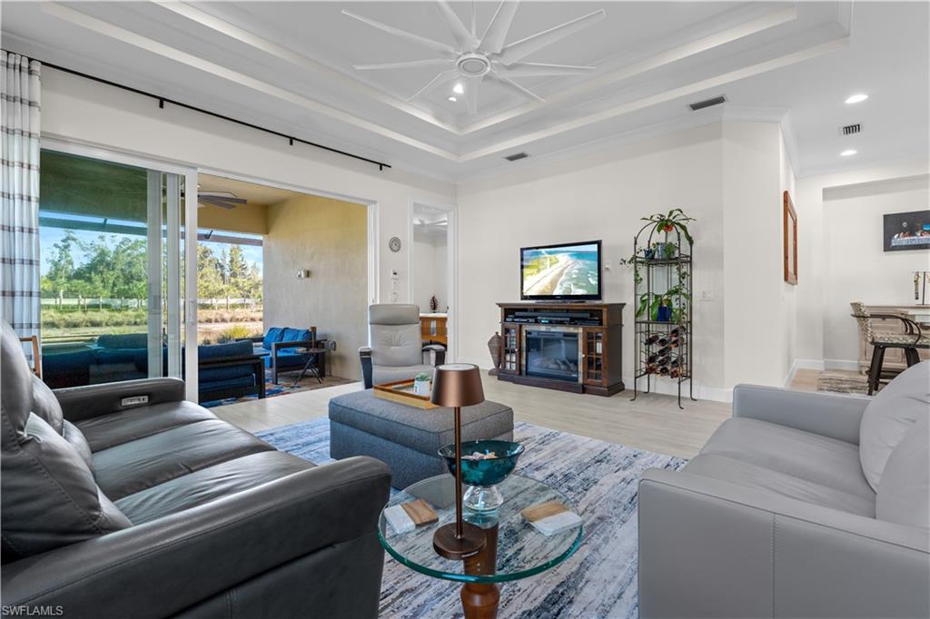 8781 Yucatan Court Naples, FL 34113 - Photo 7 of 36 a living room with furniture and a fireplace