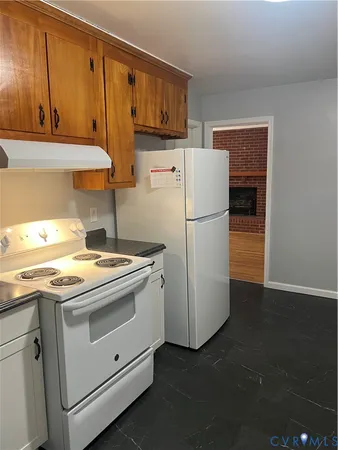 a kitchen with a stove top oven and cabinets