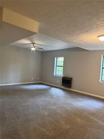 an empty room with windows and entrance