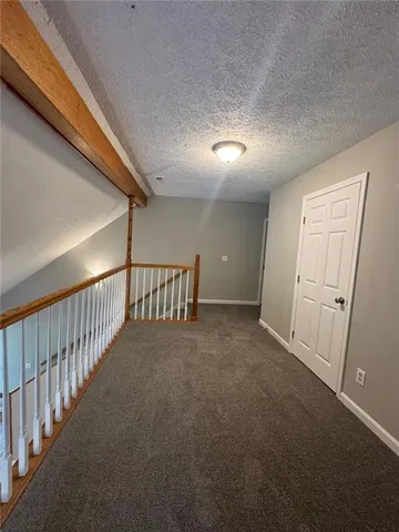 a view of a hallway with stairs