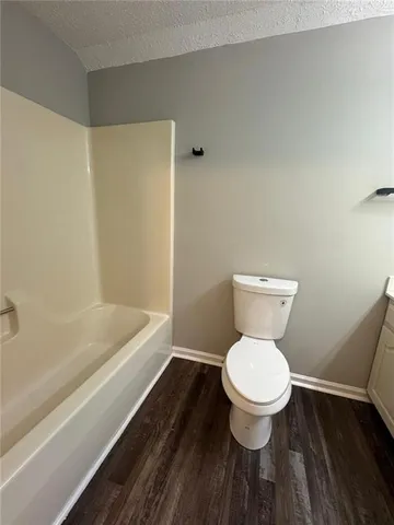 a bathroom with a toilet and a bathtub