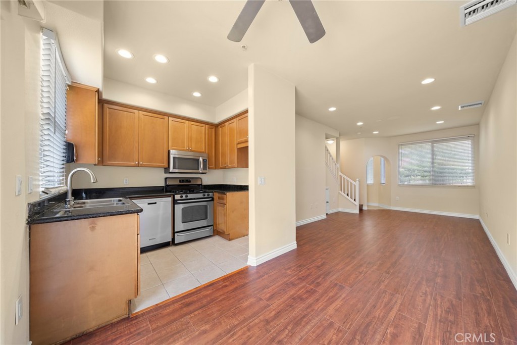 1500 Pine Avenue, Unit 9 Long Beach, CA 90813 - Photo 30 of 30 a kitchen with stainless steel appliances granite countertop a stove and a wooden floors