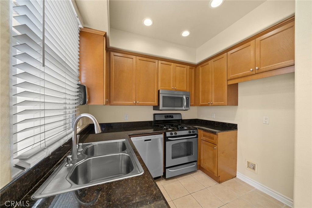 1500 Pine Avenue, Unit 9 Long Beach, CA 90813 - Photo 4 of 30 a kitchen with stainless steel appliances granite countertop a sink stove and cabinets