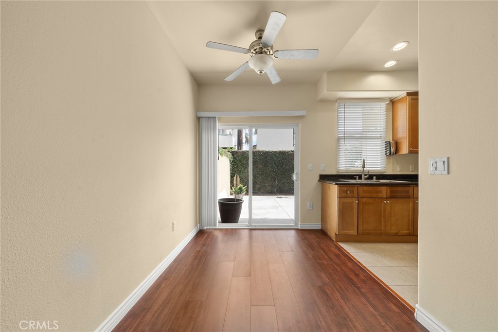 1500 Pine Avenue, Unit 9 Long Beach, CA 90813 - Photo 6 of 30 a view of a kitchen with wooden floor and a ceiling fan