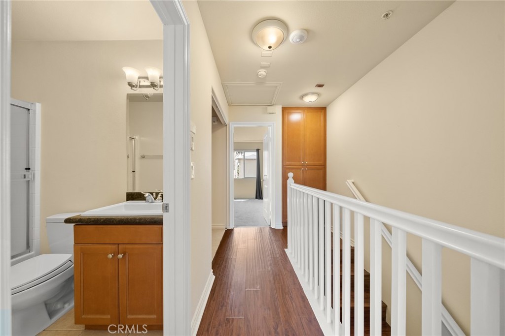 1500 Pine Avenue, Unit 9 Long Beach, CA 90813 - Photo 10 of 30 a view of a hallway with wooden floor and a bathroom