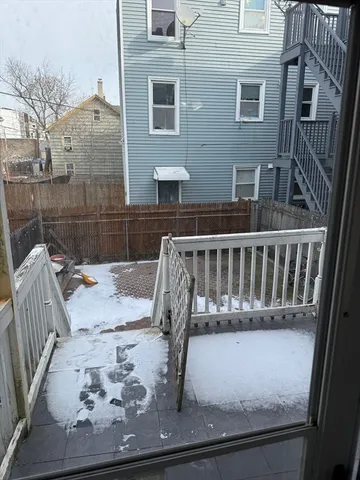 a view of house with wooden deck and furniture