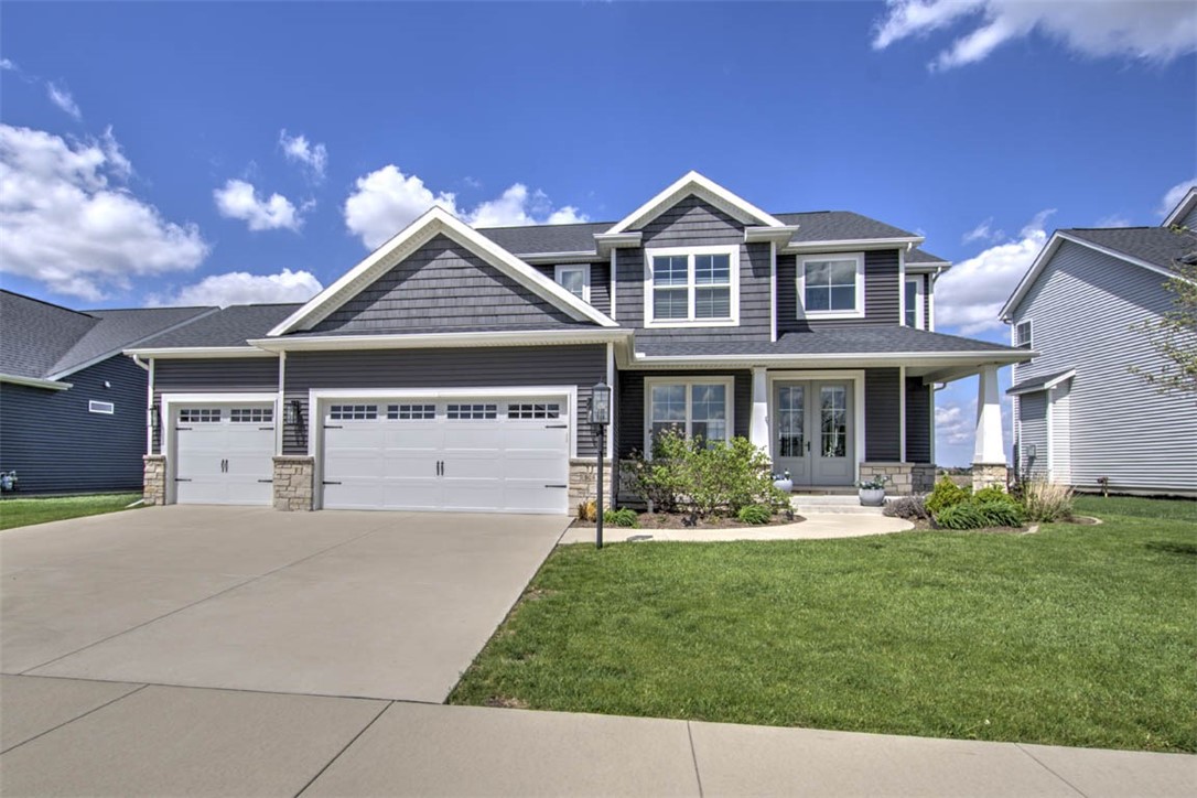 908 Declaration Drive Savoy, IL 61874 - Photo 1 of 41 a front view of a house with a yard and garage