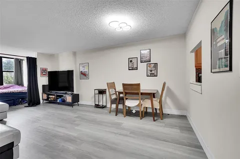 a view of a livingroom with furniture and a flat screen tv