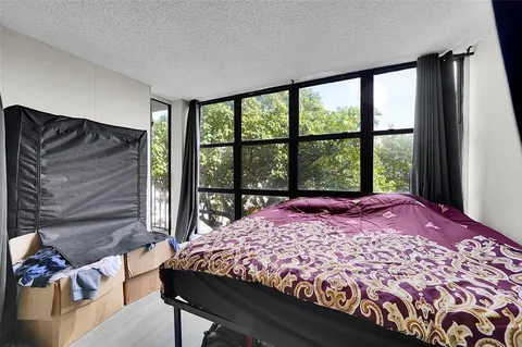 a bed sitting in a bedroom next to a window