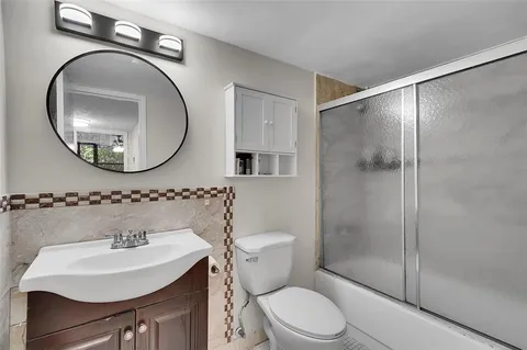 a bathroom with a sink toilet and shower