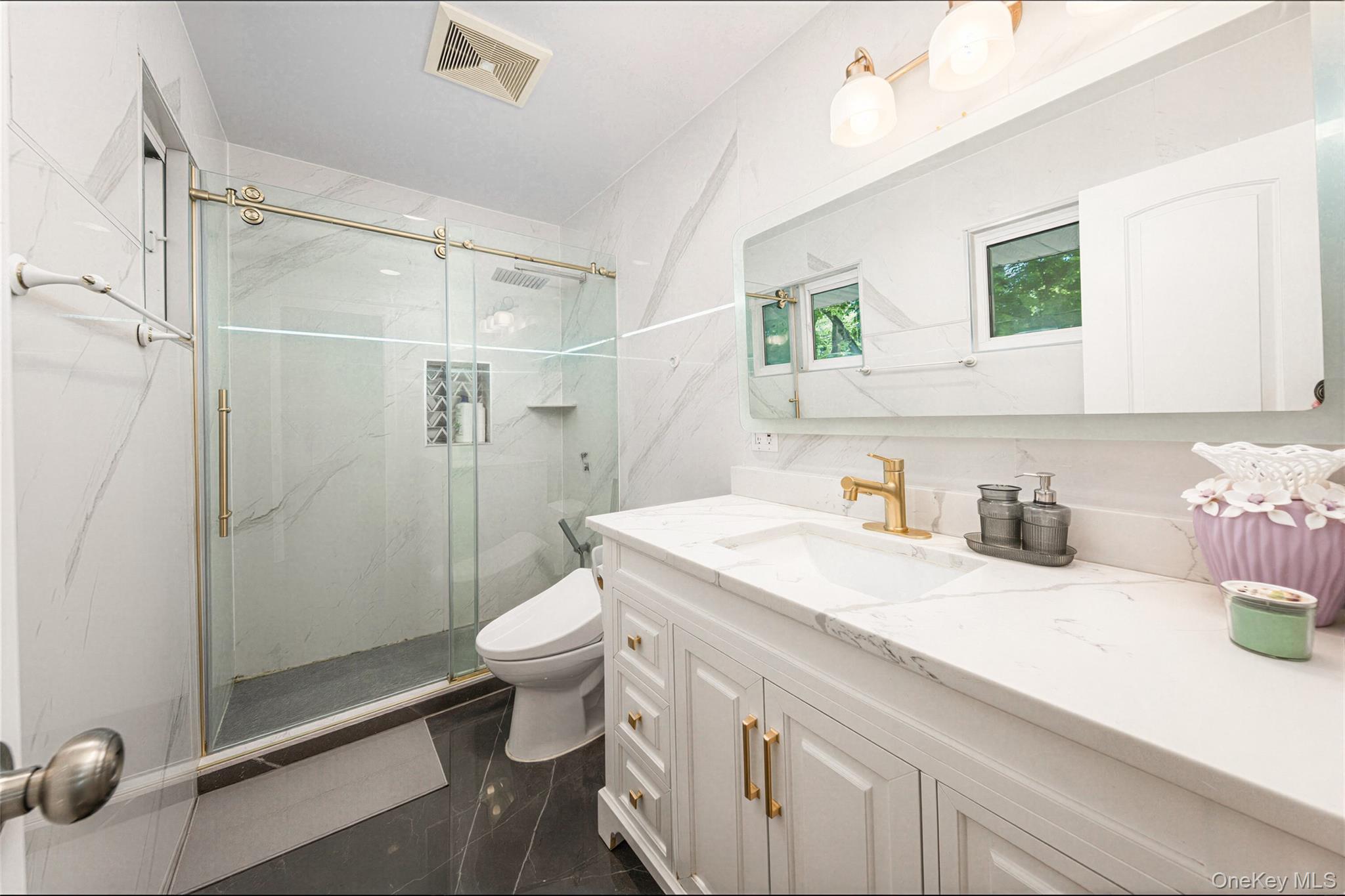 105 Seaman Road Jericho, NY 11753 - Photo 8 of 11 a bathroom with a sink a toilet and shower