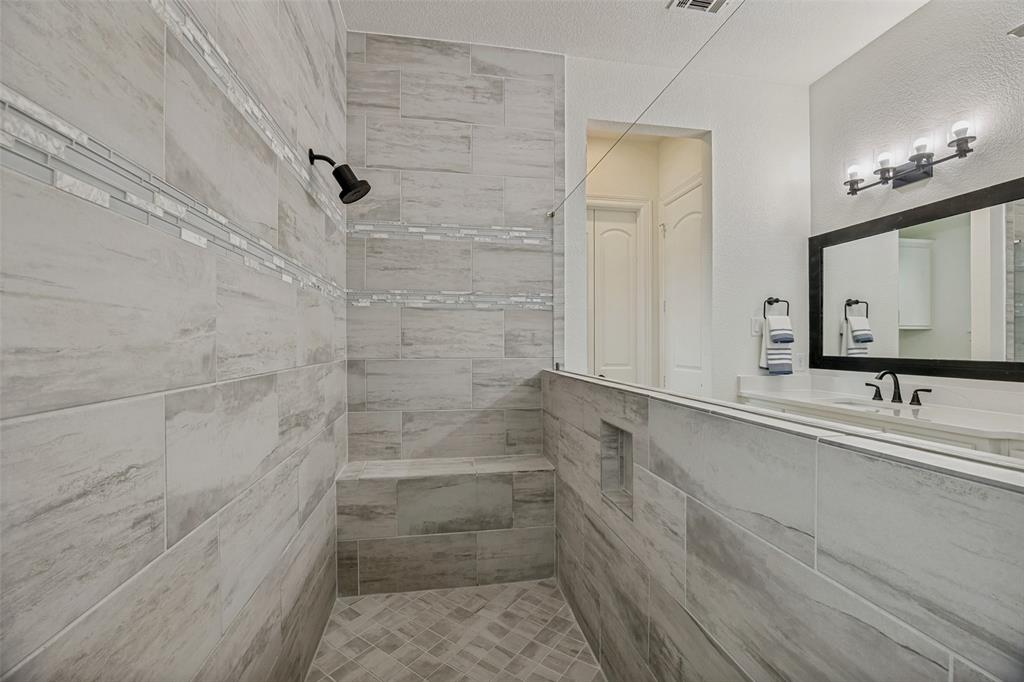 641 Maggie Trail Lucas, TX 75002 - Photo 19 of 37 a bathroom with a bathtub and a shower