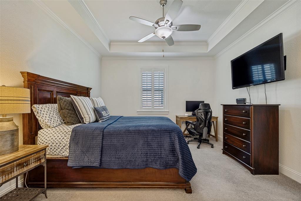 641 Maggie Trail Lucas, TX 75002 - Photo 22 of 37 a bedroom with a bed and a flat screen tv