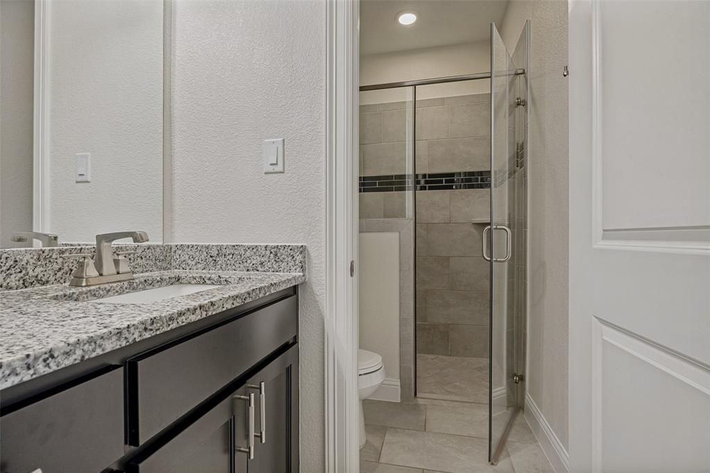 641 Maggie Trail Lucas, TX 75002 - Photo 23 of 37 a bathroom with a granite countertop sink and a mirror
