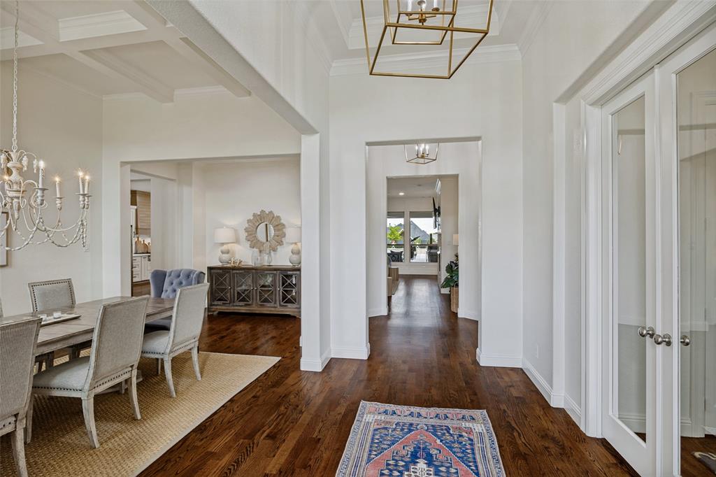 641 Maggie Trail Lucas, TX 75002 - Photo 3 of 37 a dining room with furniture wooden floor a rug and a chandelier