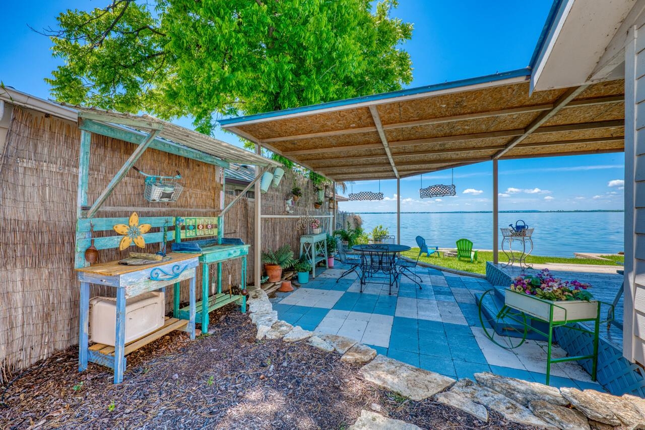 809 Lakeshore Loop Tow, TX 78672 - Photo 19 of 33 a view of a patio with table and chairs under an umbrella