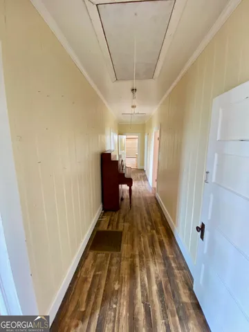 a view of an empty room with a fireplace and a window