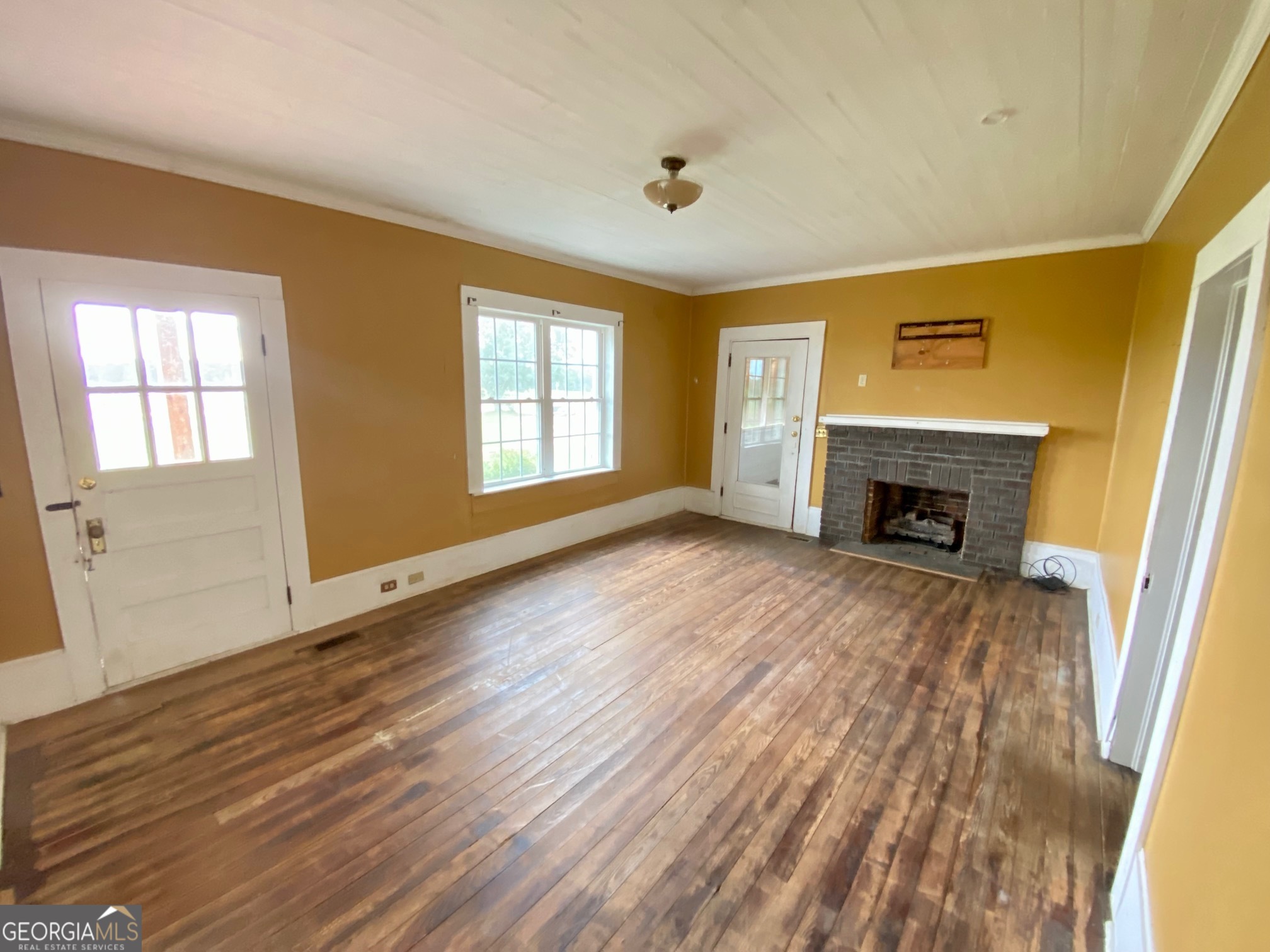 1088 Tippettville Road Pineview, GA 31071 - Photo 8 of 33 a view of an empty room with wooden floor and a window