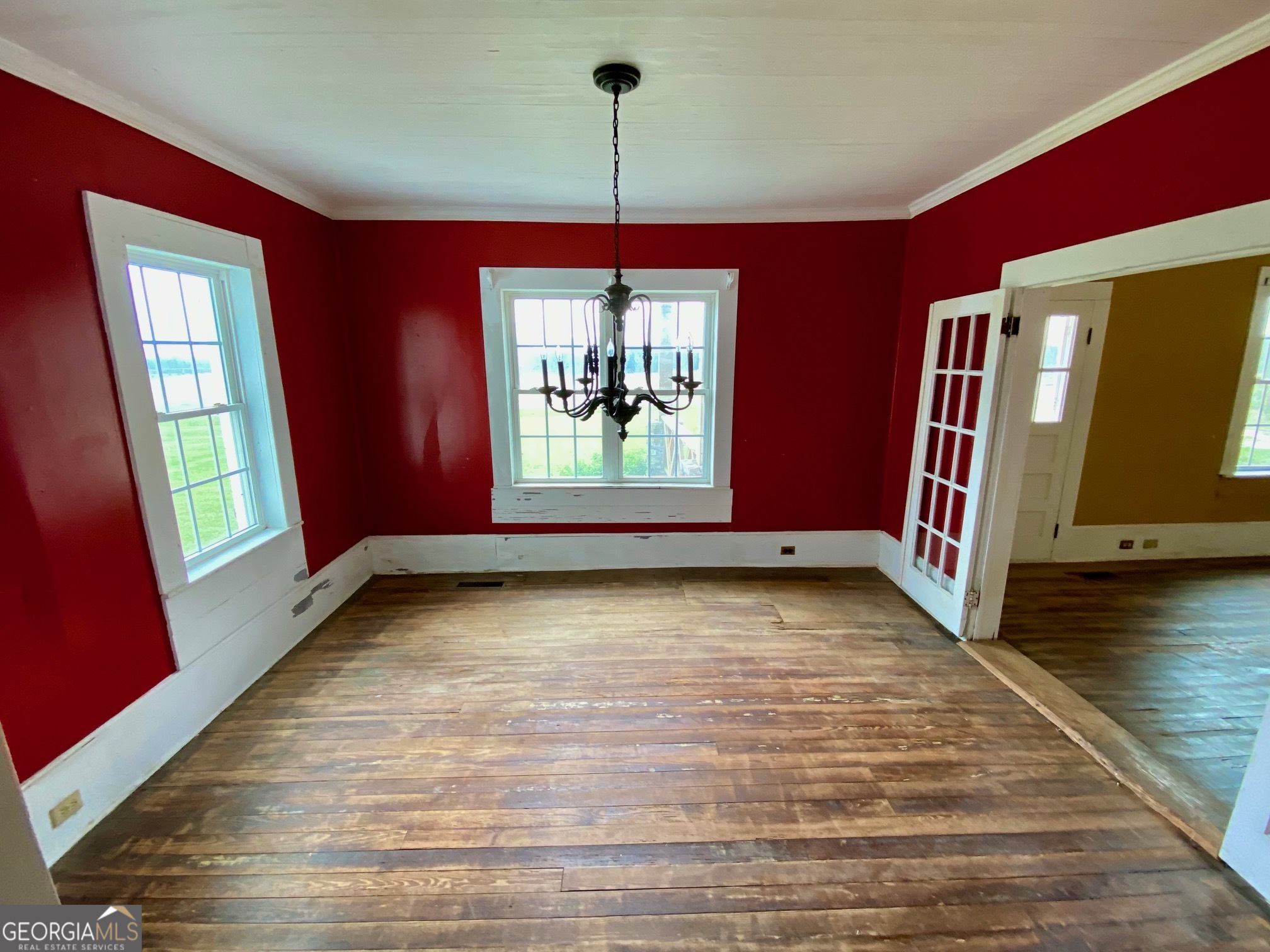 1088 Tippettville Road Pineview, GA 31071 - Photo 9 of 33 a view of an empty room with window wooden floor and front door