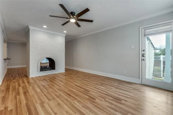 a view of a livingroom with a fireplace and wooden floor
