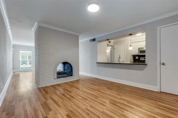 a view of a room with wooden floor and a window