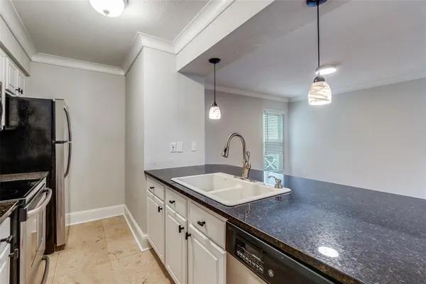 a kitchen with stainless steel appliances granite countertop a sink refrigerator and microwave