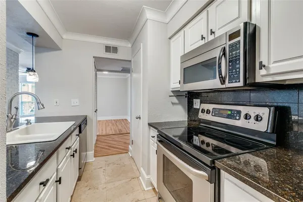 a kitchen with a stove and a microwave