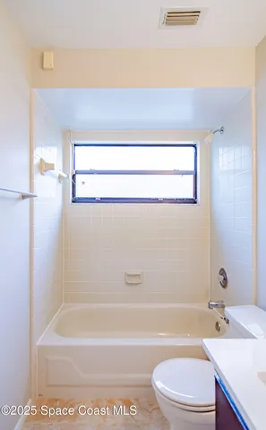 a bathroom with a sink toilet vanity and bathtub