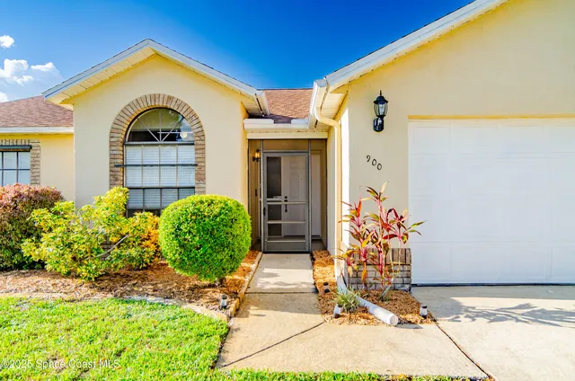 a view of a brick house with potted plants