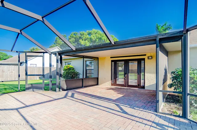 a front view of a house with a garden and trees