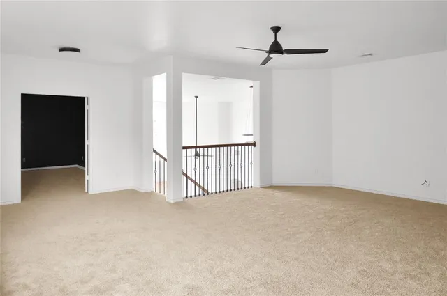 an empty room with closet and windows