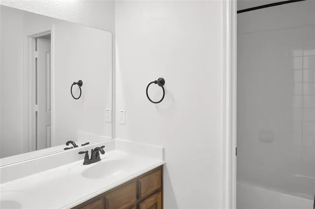 a front view of a house with a garden and yard