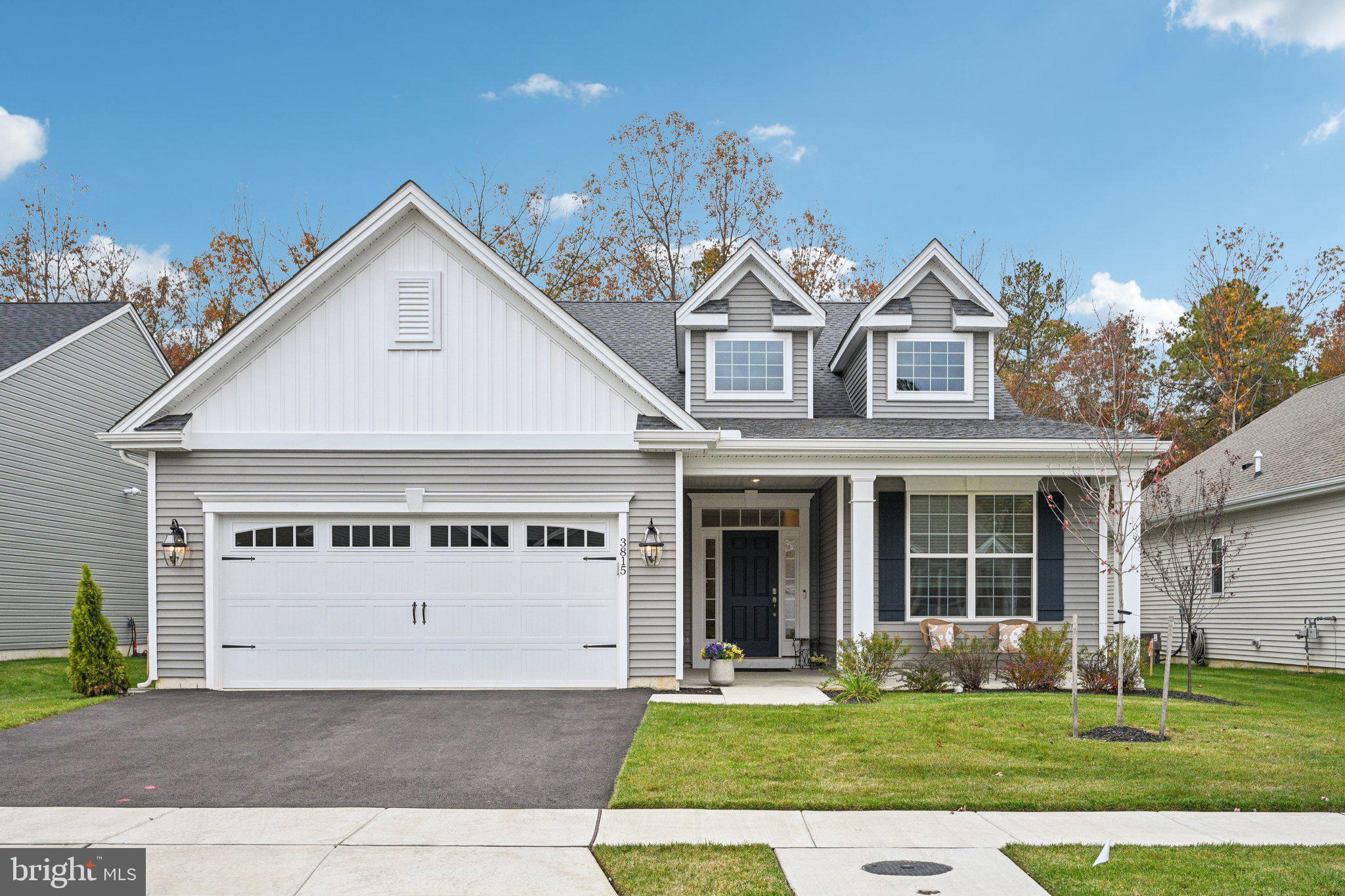a view of white house with a yard and garage