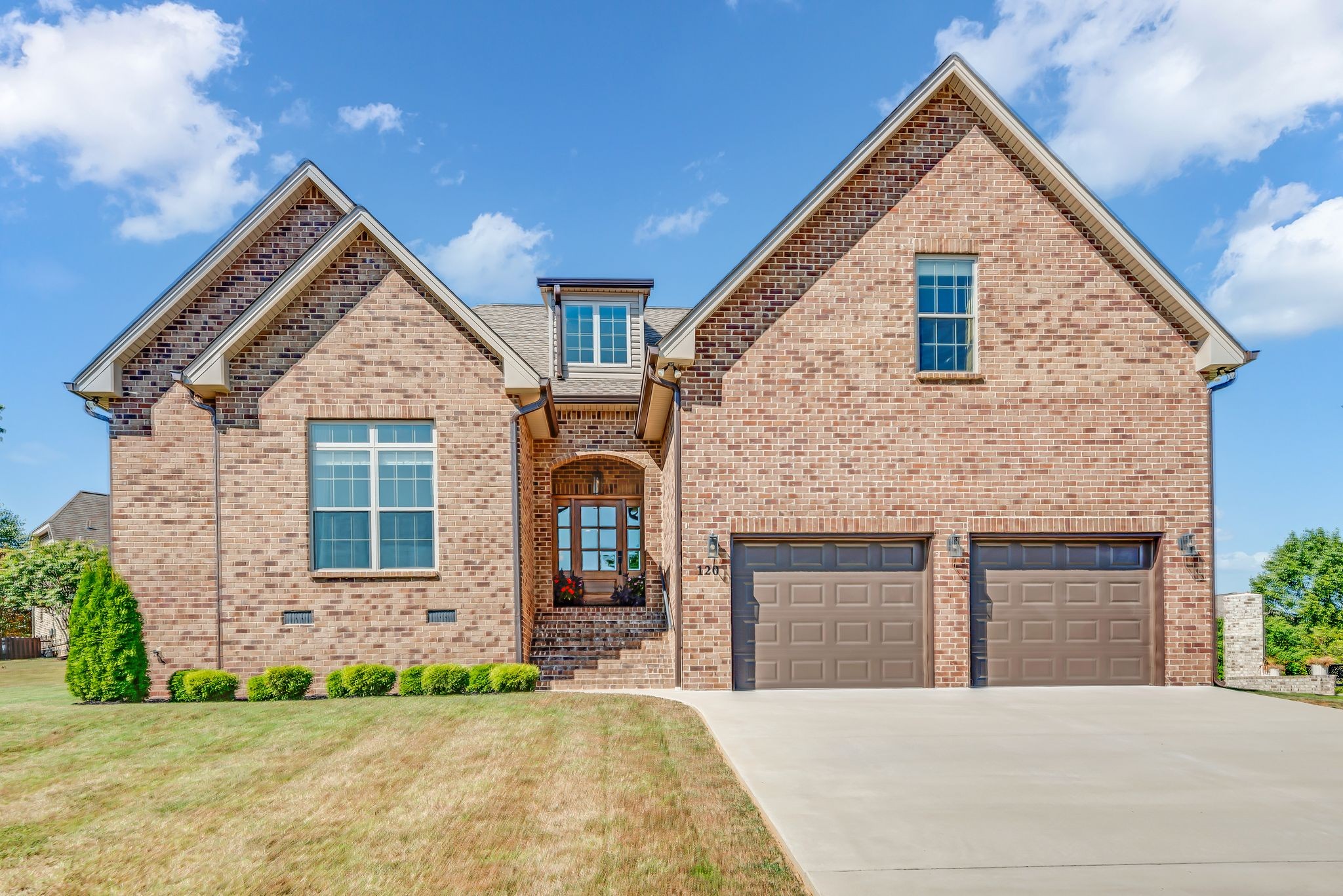 a front view of a house with yard