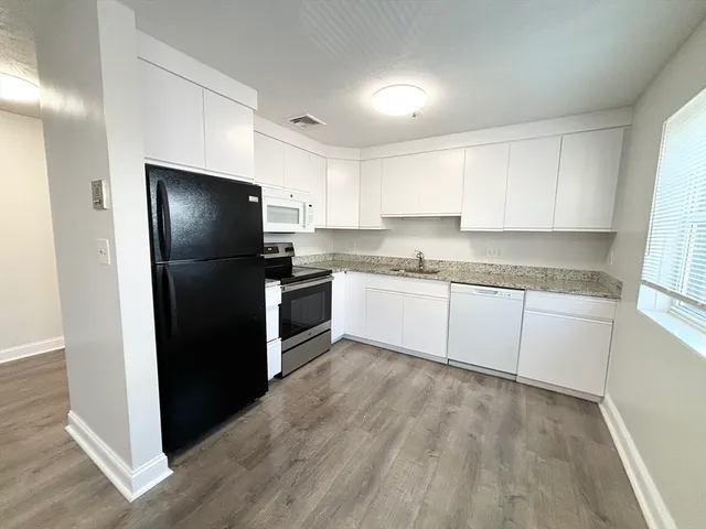 a kitchen with a refrigerator and a sink