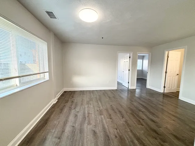 a view of a kitchen with wooden floor