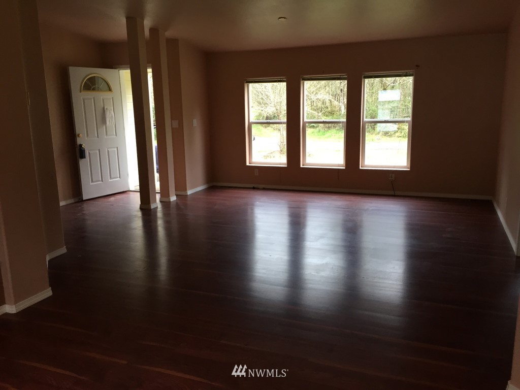 21922 Summers Road Centralia, WA 98531 - Photo 3 of 17 an empty room with wooden floor and windows