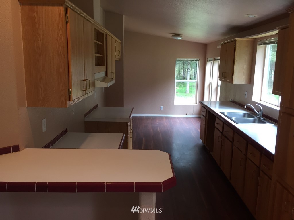 21922 Summers Road Centralia, WA 98531 - Photo 6 of 17 a kitchen with kitchen island a sink appliances and cabinets