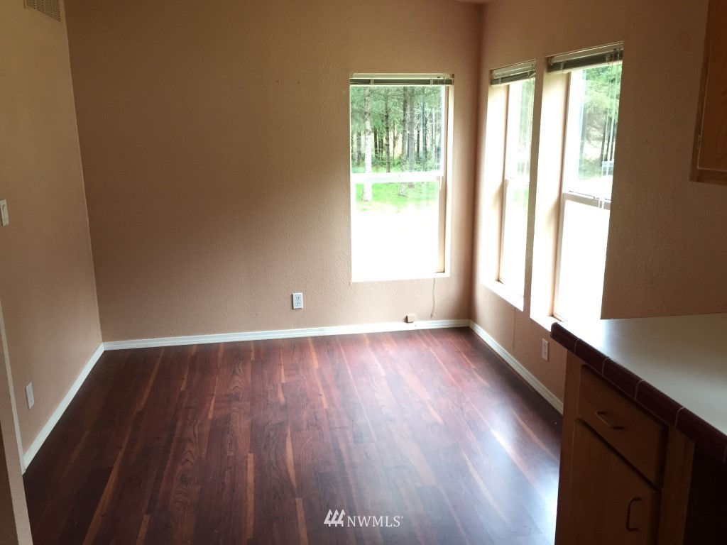 21922 Summers Road Centralia, WA 98531 - Photo 7 of 17 a view of an empty room with wooden floor and a window