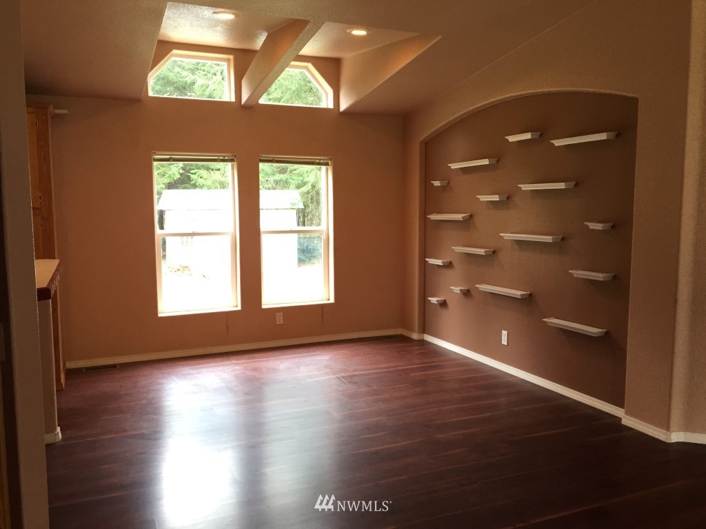 21922 Summers Road Centralia, WA 98531 - Photo 8 of 17 an empty room with windows and wooden floor