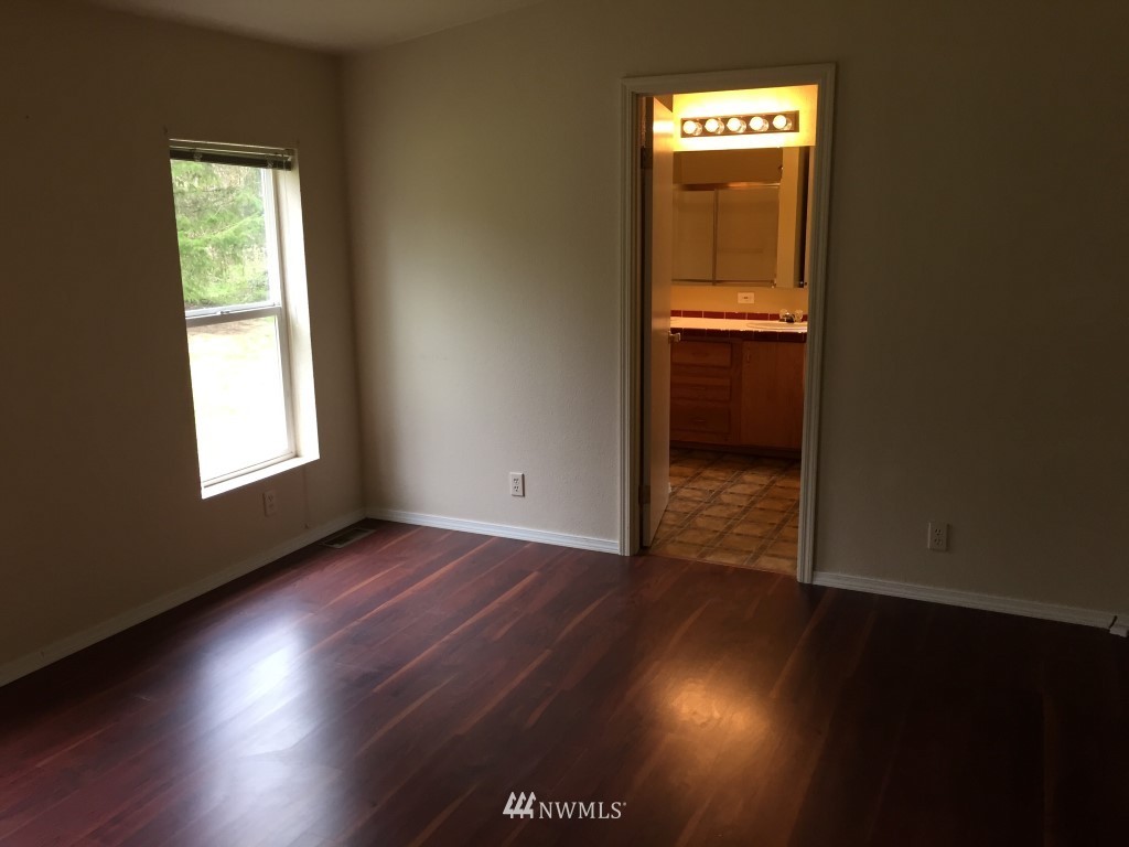 21922 Summers Road Centralia, WA 98531 - Photo 10 of 17 an empty room with wooden floor and windows